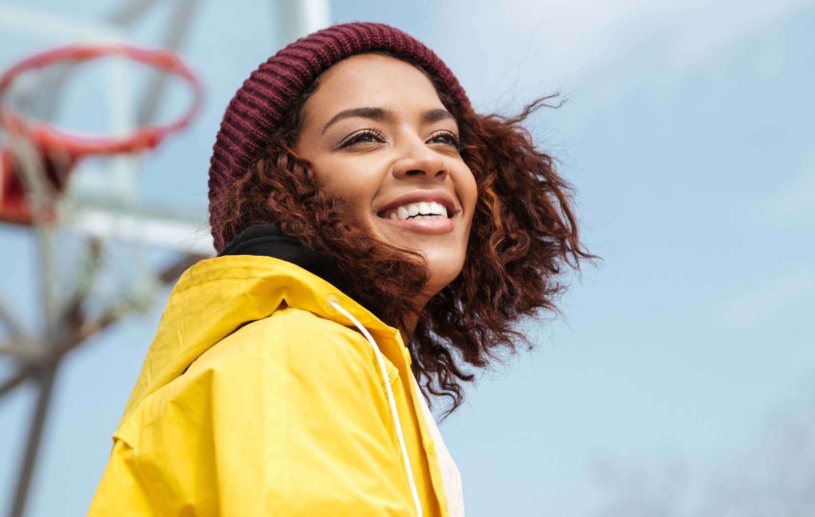 Woman on basketball court smiling