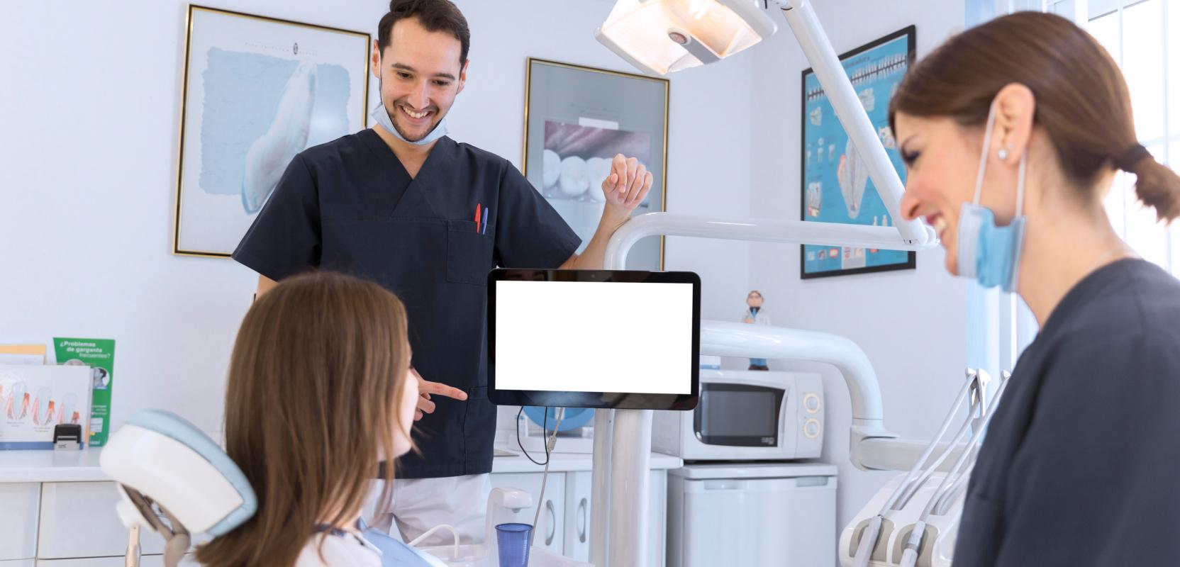 Two team members showing a patient their screen